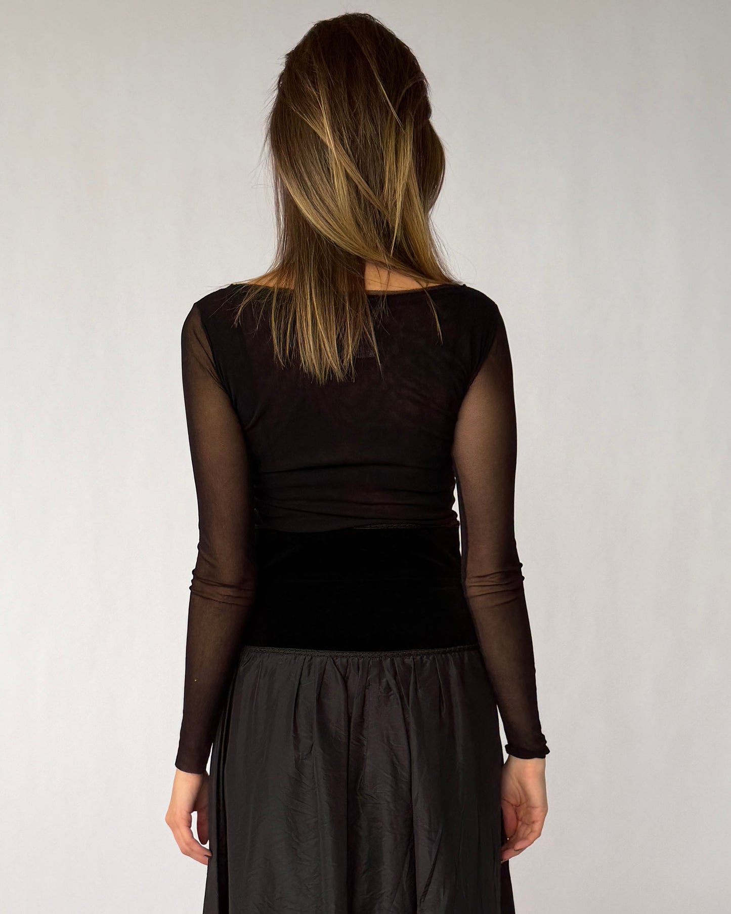 Back view of Fuzzi long sleeve mesh top