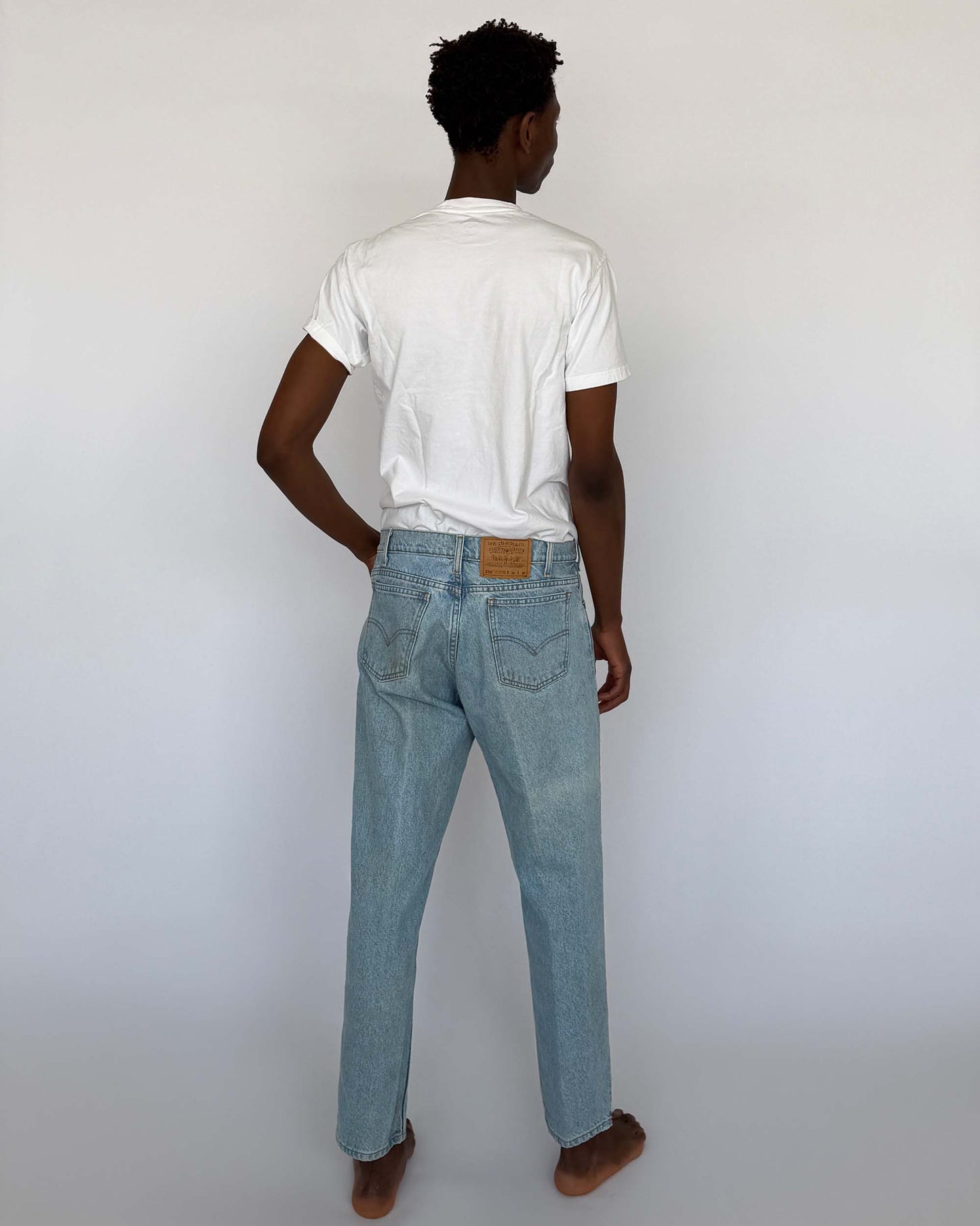 Back view of light wash vintage Levi's 550