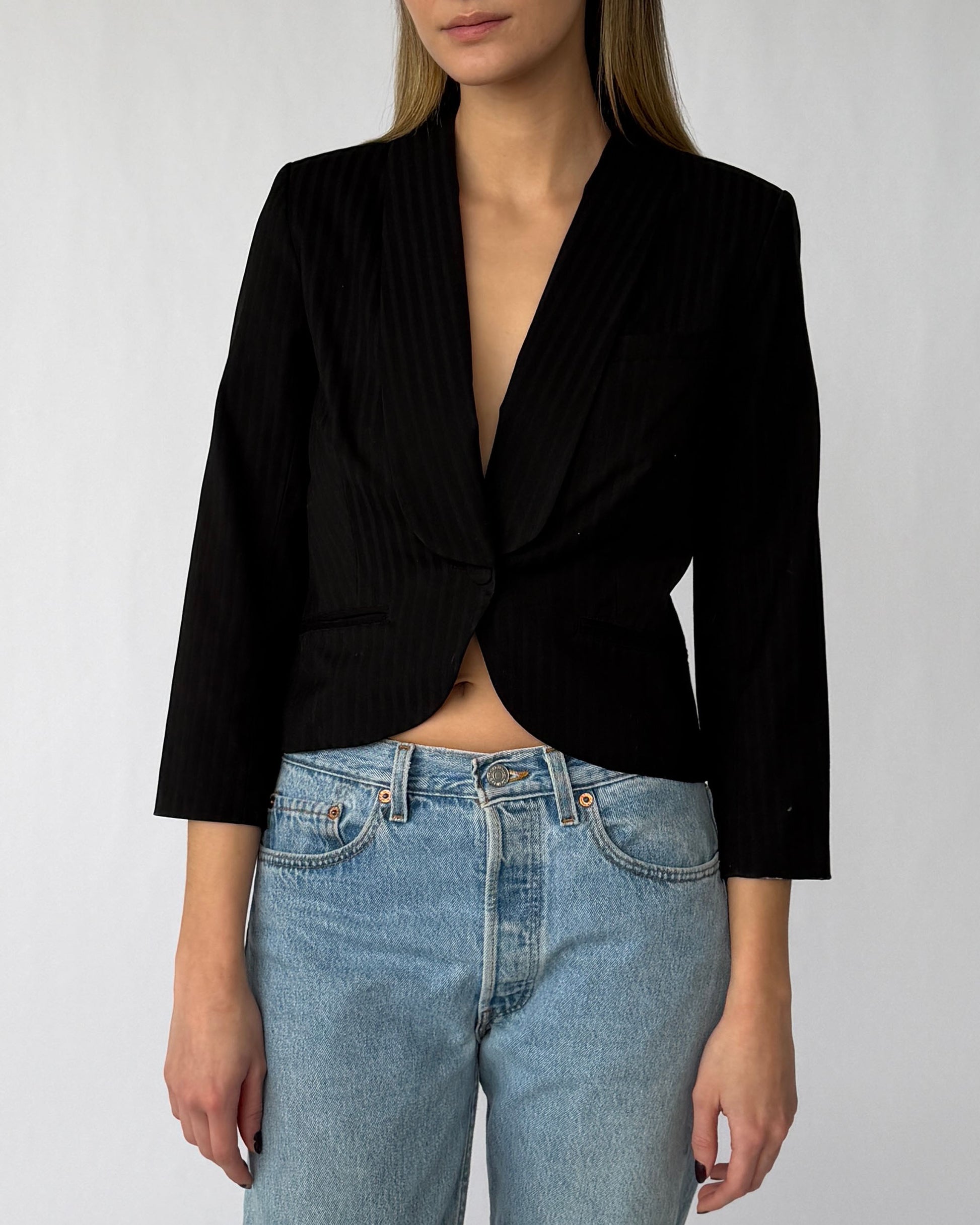 Close-up view of Alexander McQueen pinstripe blazer with three quarter sleeves