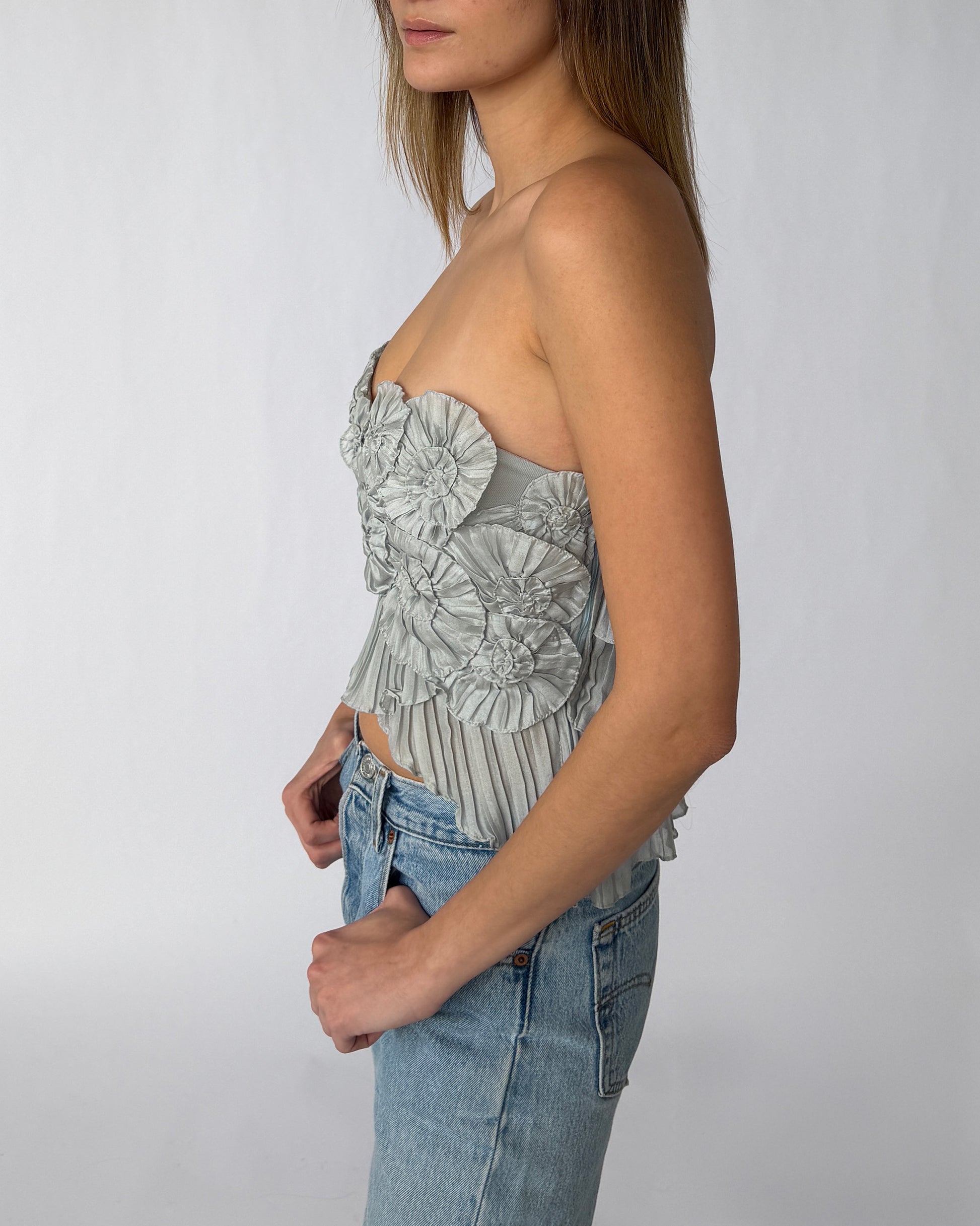Side view of BCBGMAXAZRIA sculptural strapless top