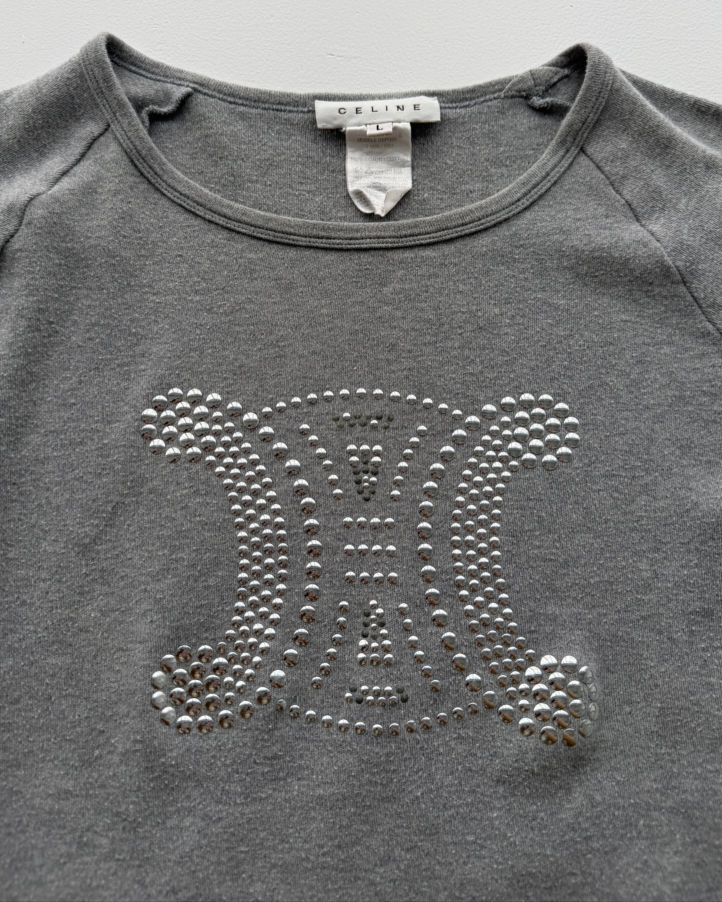 View of label and studded logo on early 2000s Celine long sleeve top