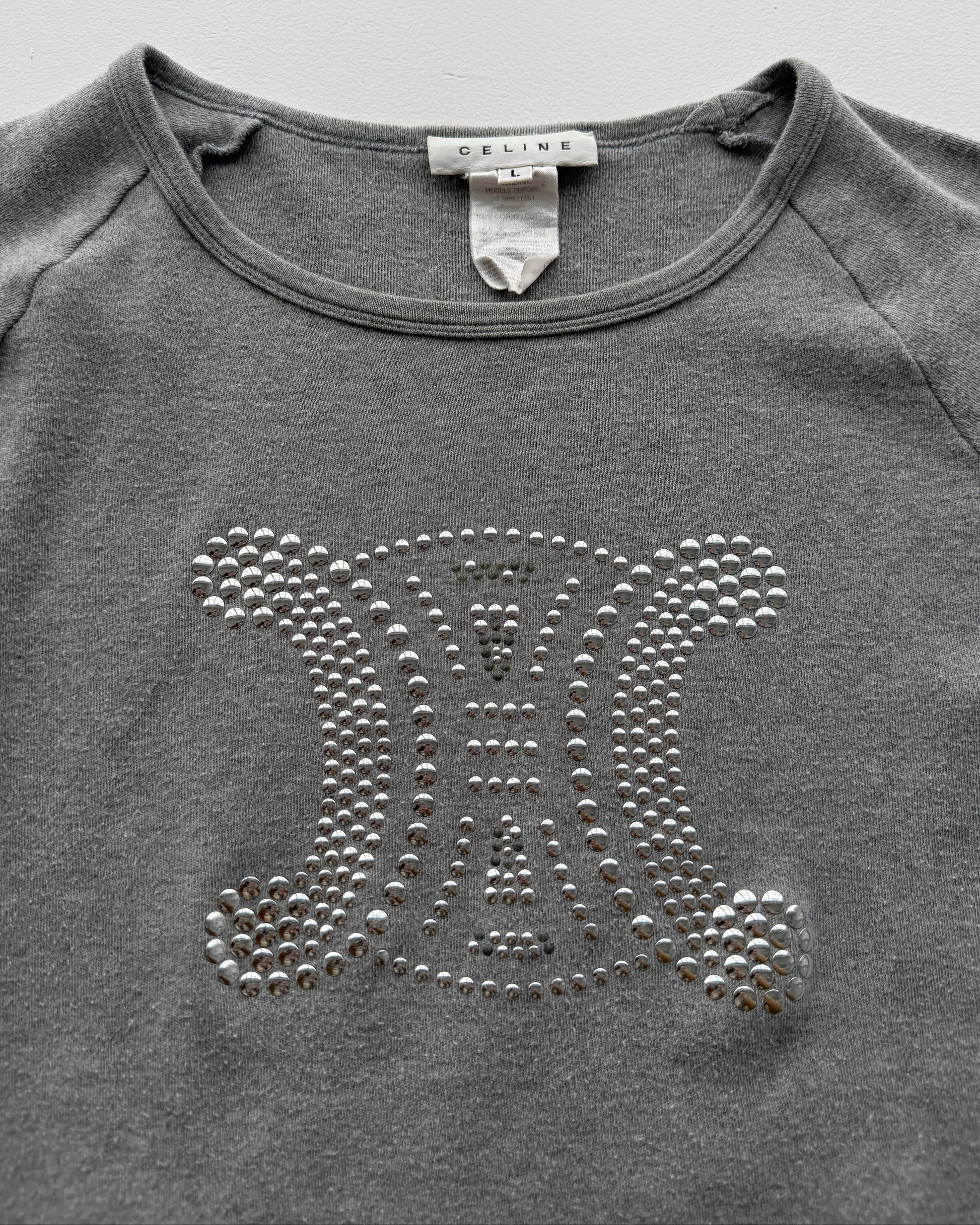 View of label and studded logo on early 2000s Celine long sleeve top