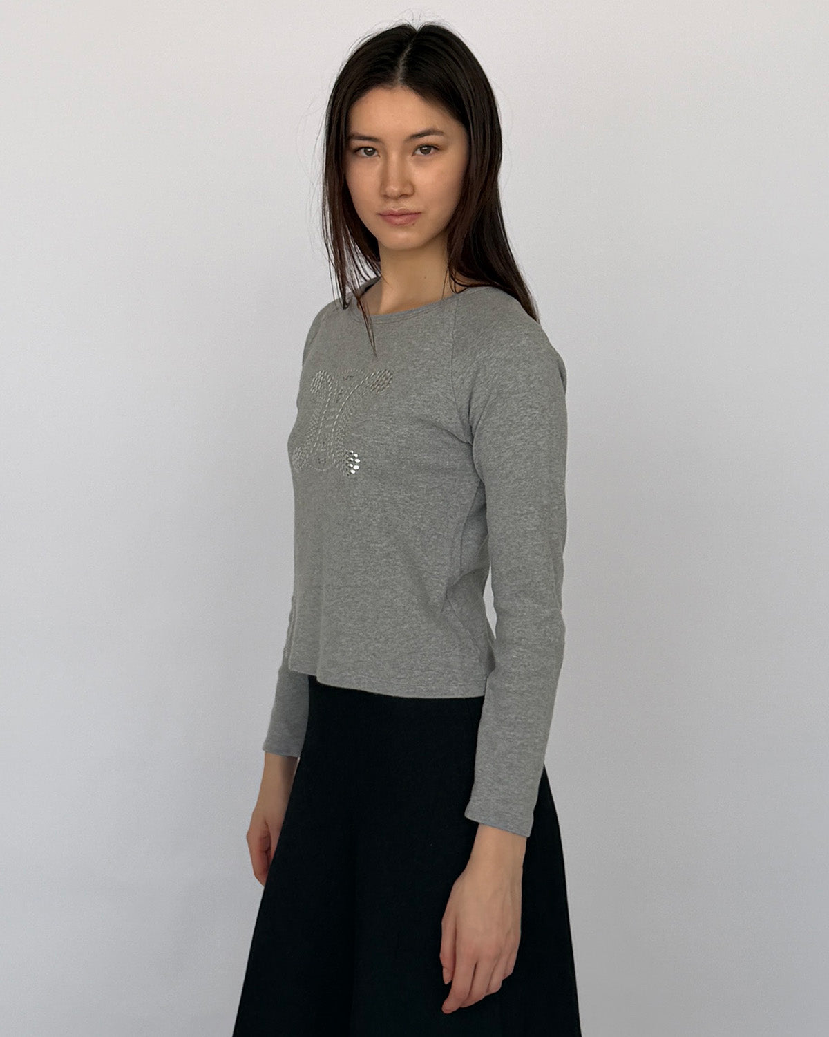Side view of early 2000s Celine long sleeve top with studded logo