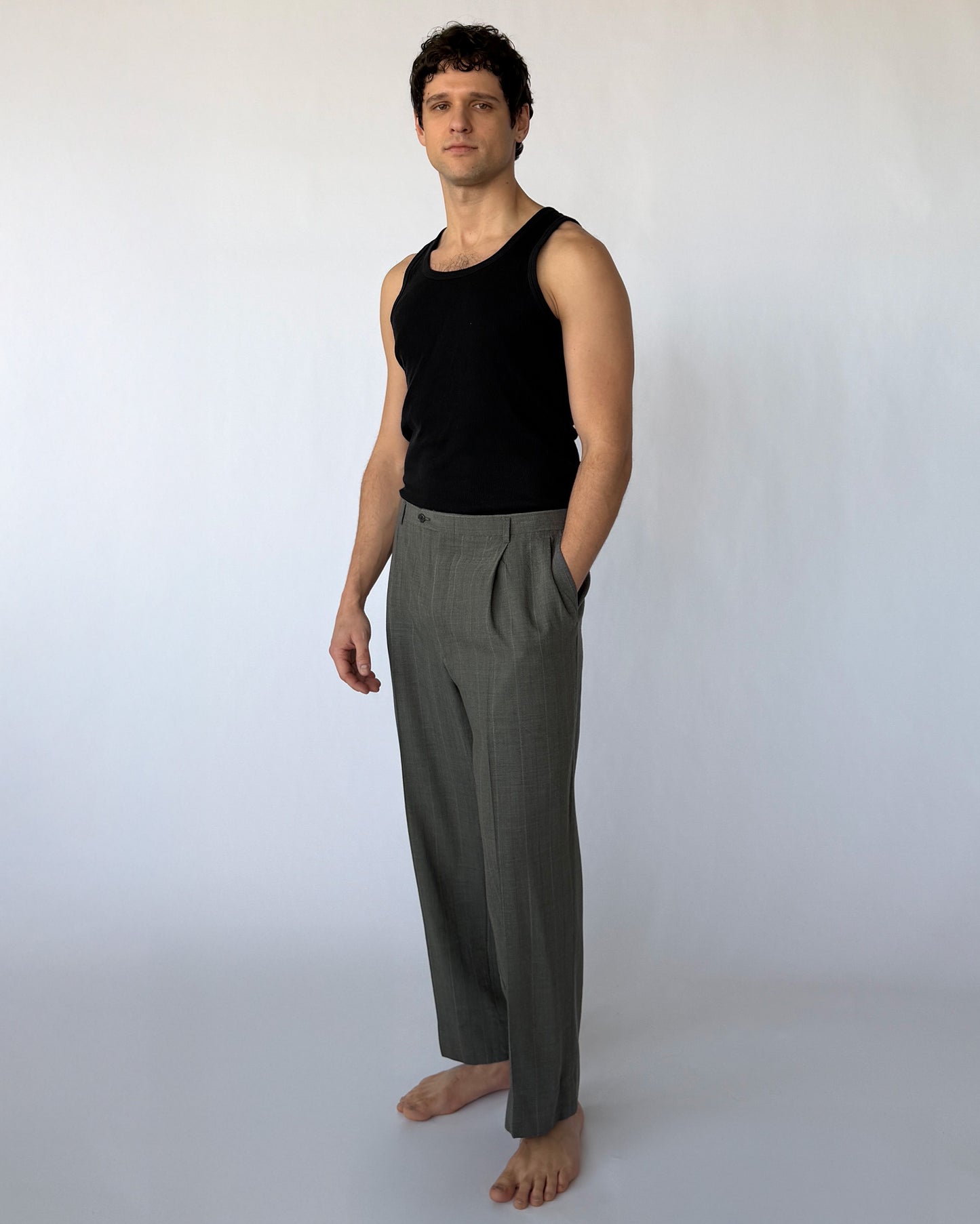 Side view of vintage Christian Dior Grey pinstripe pleated men's trousers