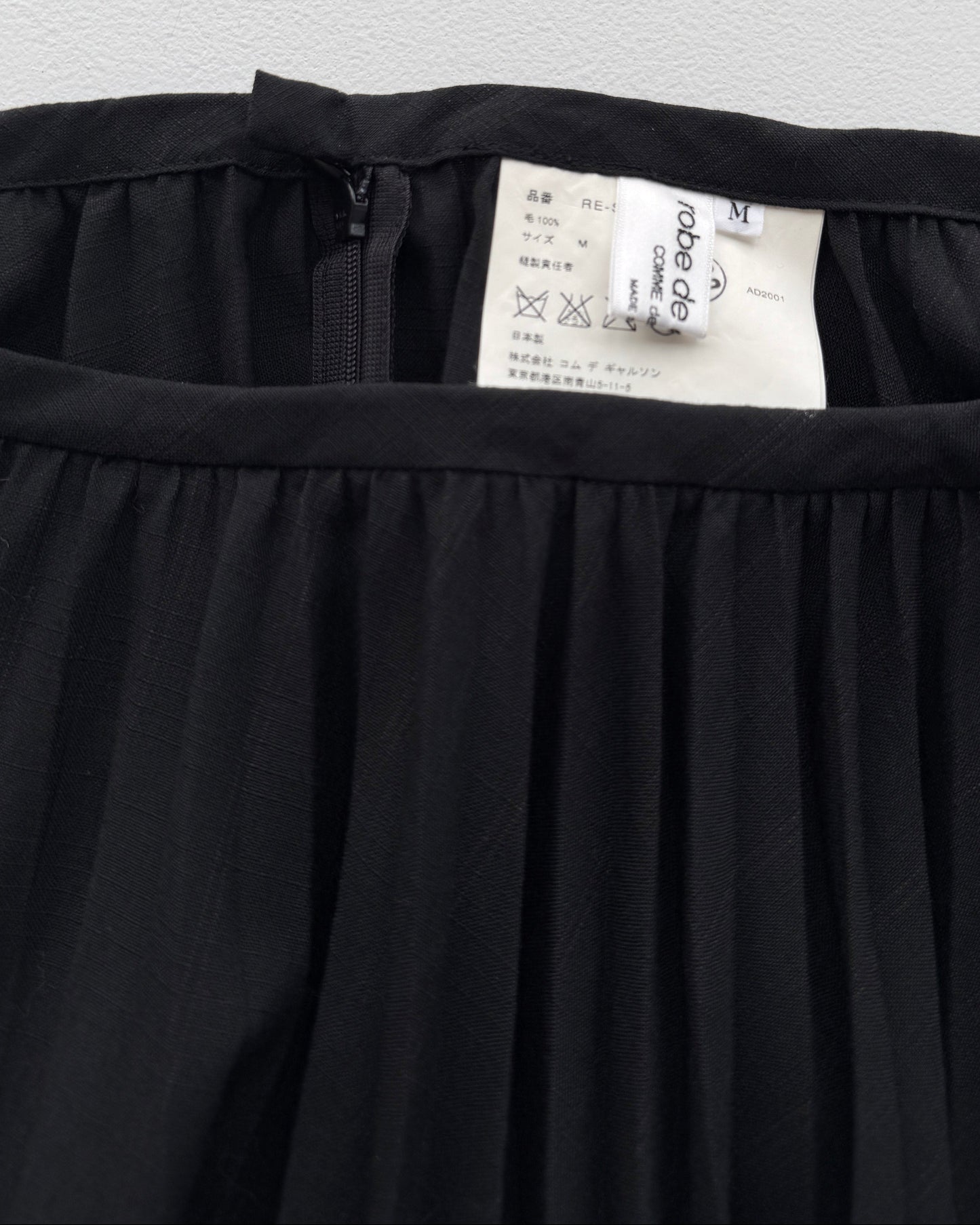 Label on  Comme des Garçon Black Wool Pleated Skirt