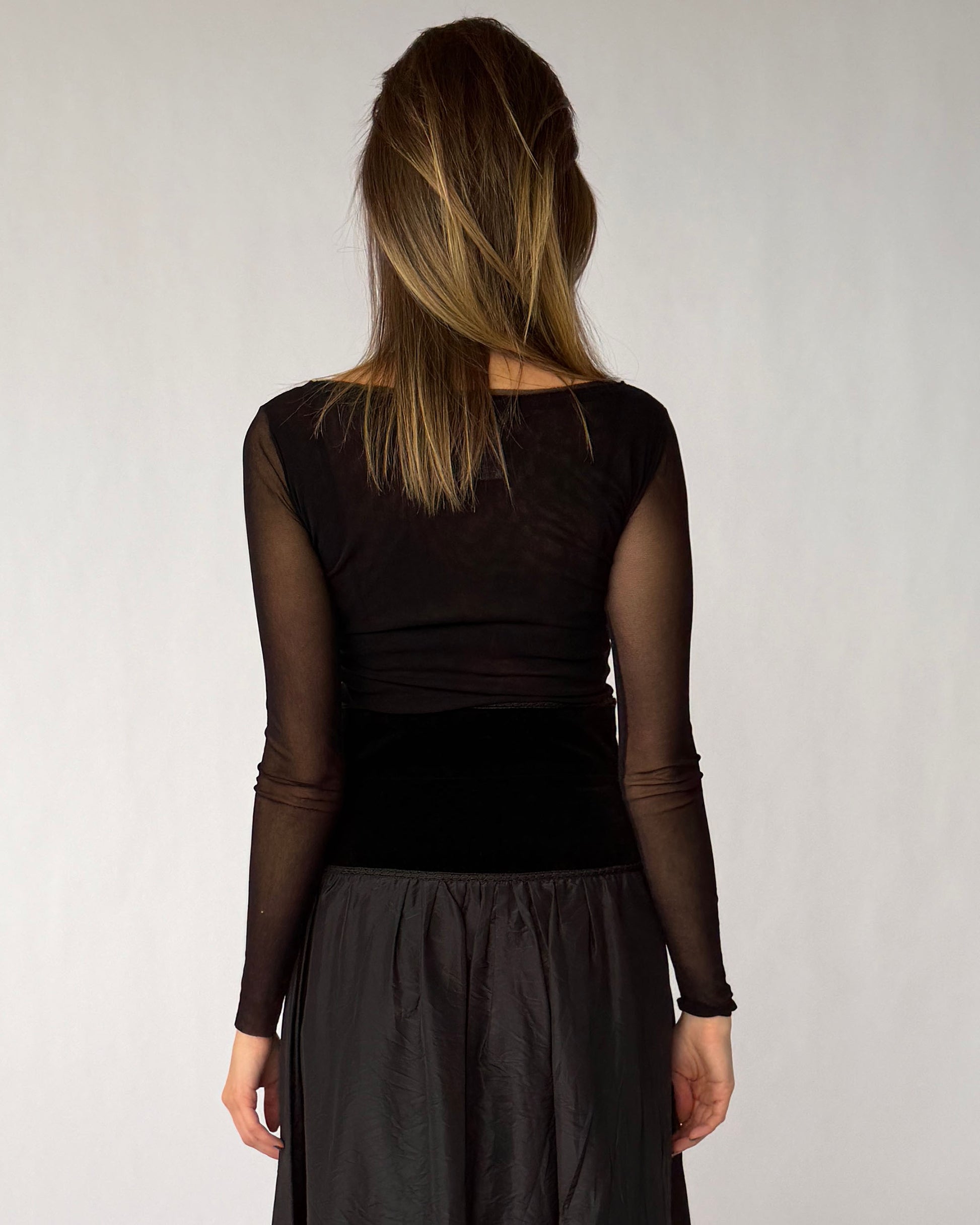 Back view of Fuzzi long sleeve mesh top