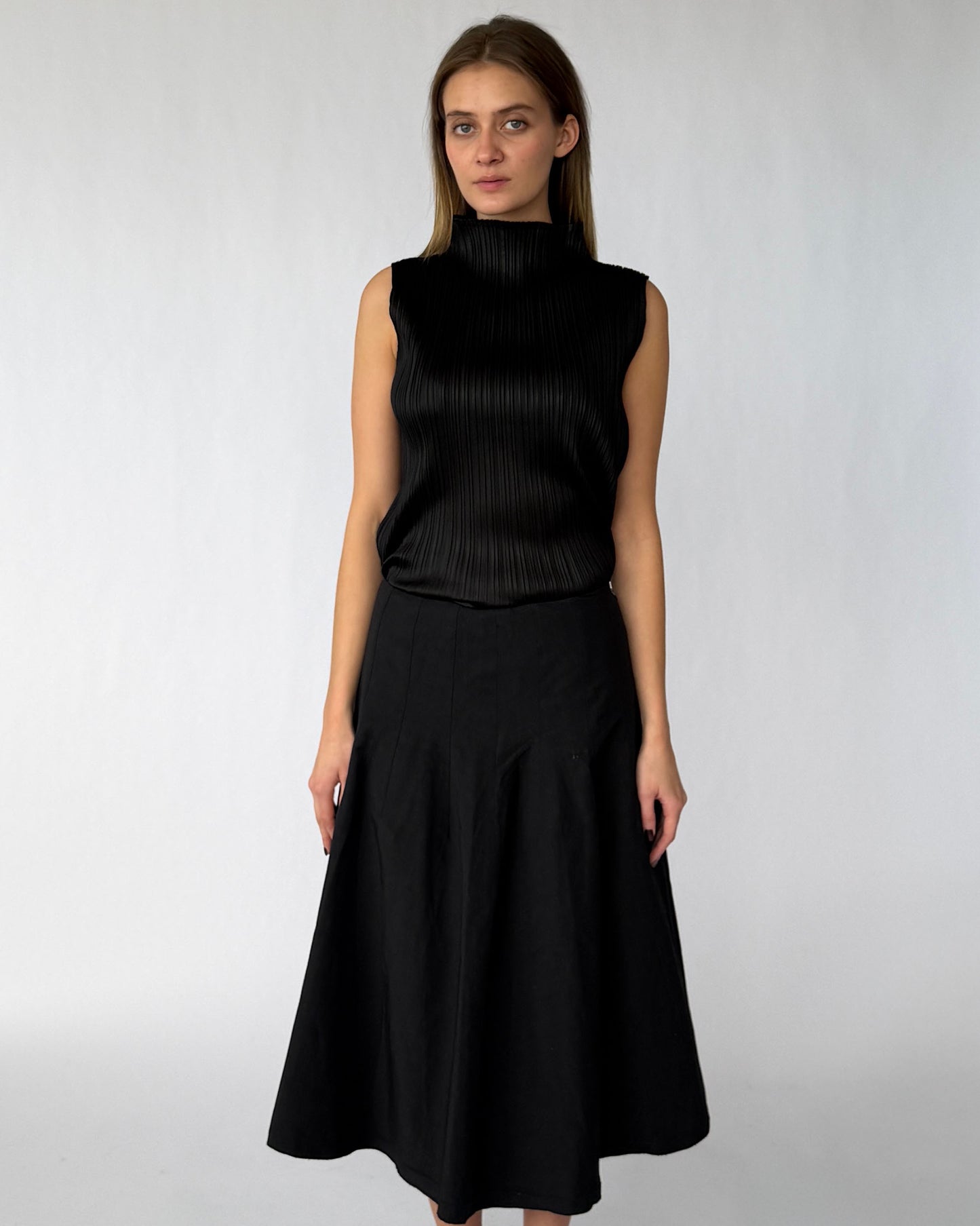 Issey Miyake Pleats Please black sleeveless blouse with mock-neck worn on model