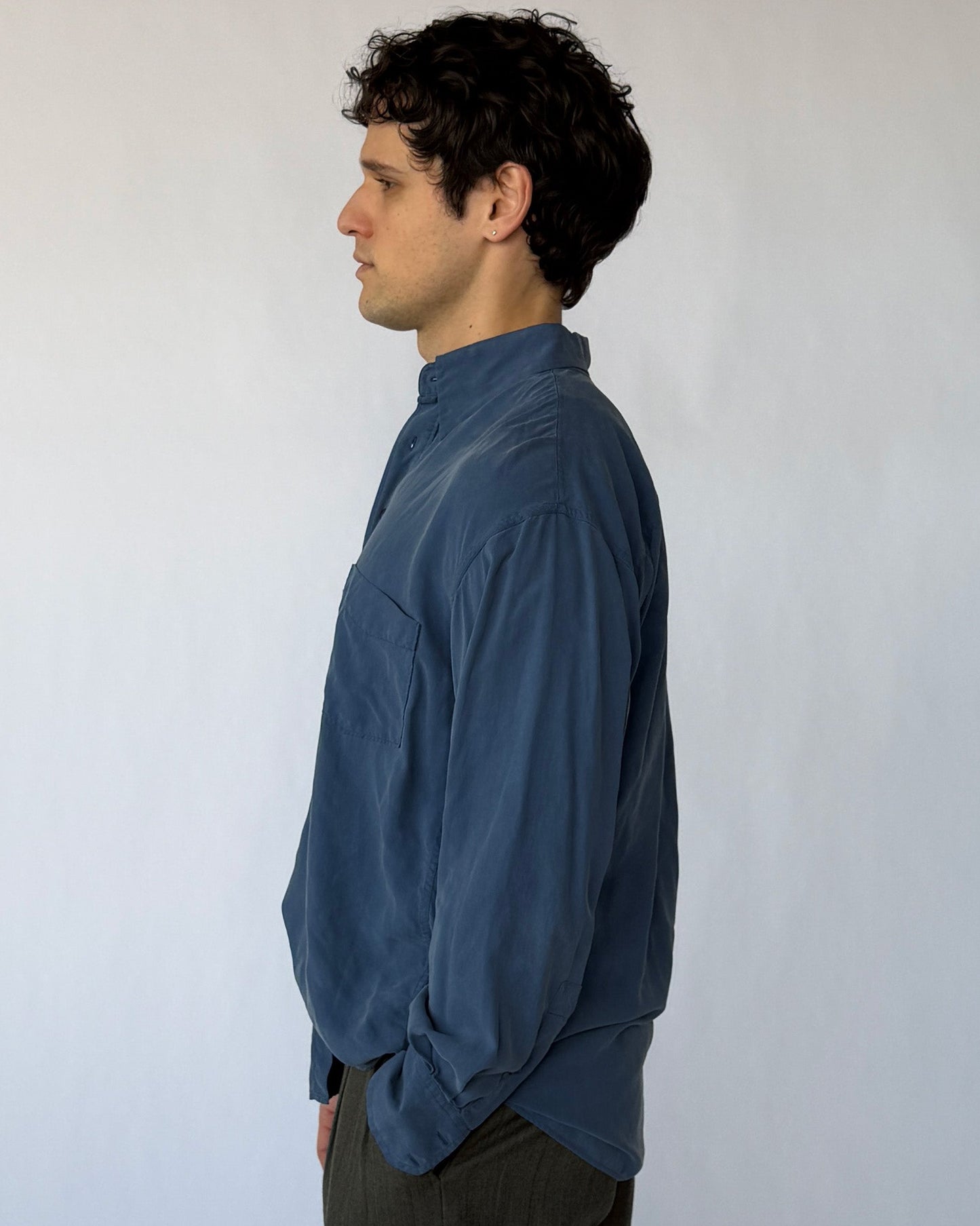 Side profile of vintage blue silk button-up shirt showing loose fit and lightweight fabric