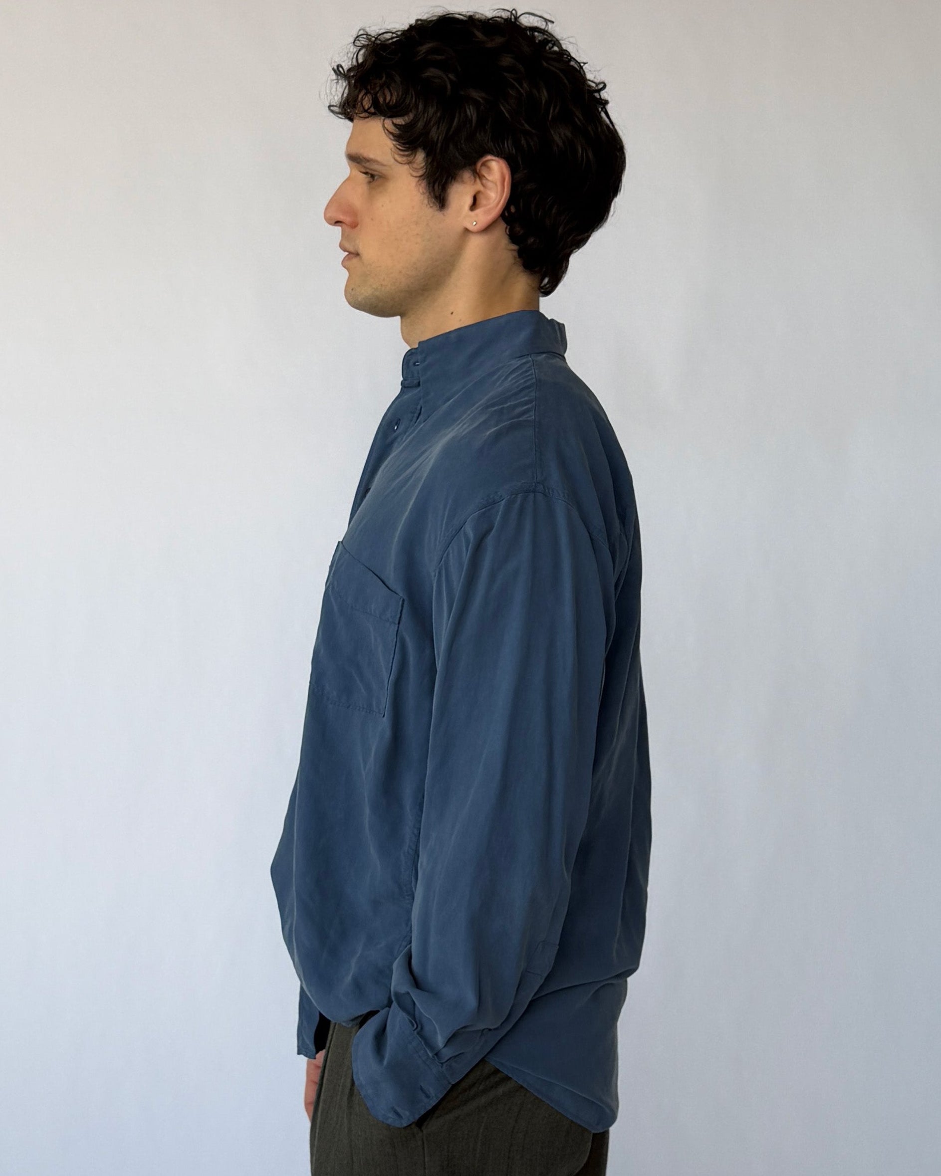 Side profile of vintage blue silk button-up shirt showing loose fit and lightweight fabric