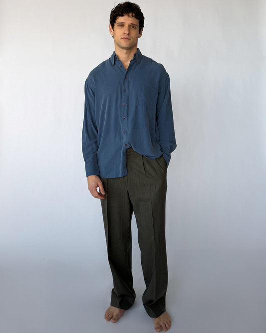 Vintage blue silk button-up shirt worn by model, relaxed fit long sleeve front view